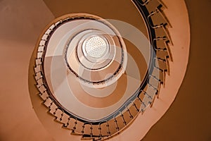Modern abstract spiral staircase from below, bauhaus style, golden warm tone photo