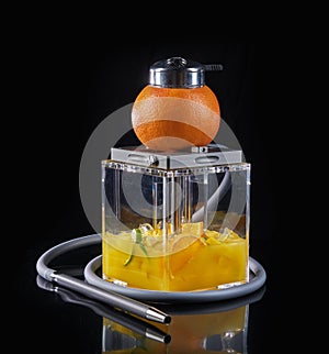 Modern acrylic hookah with citrus fruits and ice cubes on black background