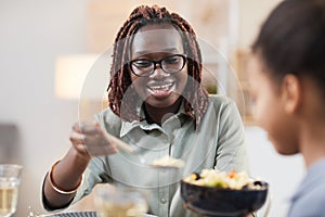 Modern African American Woman Serving Dinner to Family