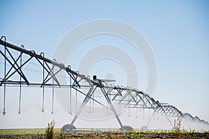 Modern agricultural irrigation system spraying in field