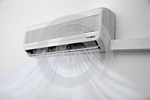 Modern air conditioner on white wall
