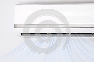 Modern air conditioner on white wall