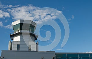 Modern air traffic control tower in international passenger airport over blue sky with copy space