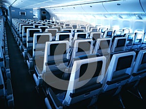 Modern aircraft interior with seats and blank touch entertainment