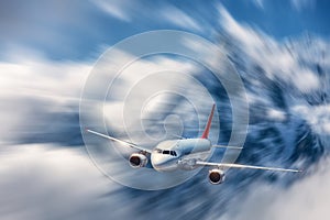 Modern airplane mith motion blur effect at sunny bright day. Lan