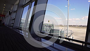 Modern airport, beautiful view of runway and passenger terminal through window