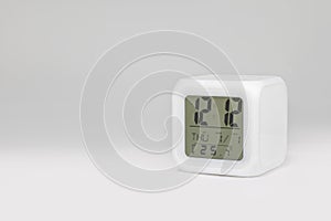 Modern alarm clock on white backdrops and copyspace. LED light or digital display