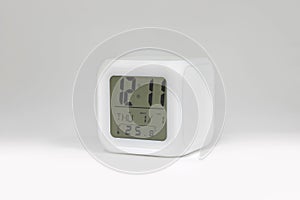 Modern alarm clock on white backdrops and copyspace. LED light or digital display