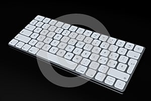 Modern aluminum computer keyboard isolated on black background.