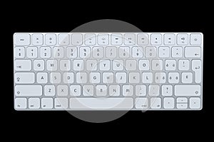 Modern aluminum computer keyboard isolated on black background.