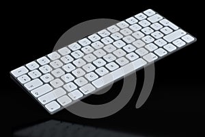Modern aluminum computer keyboard isolated on black background.