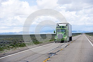 Modern American semi truck and reefer trailer on Nevada road