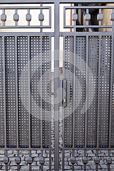 Modern anthracite panel fence, visible sliding gate to the garage, view from the garden