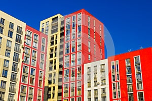 Modern apartment architecture estate complex building red white and yellow facade wall in clear weather time and blue sky