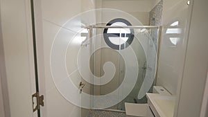 Modern apartment bathroom tour, showcasing shower, sink, fixtures in small urban living space amid rising housing costs.