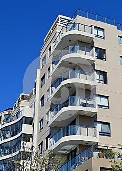 A modern apartment block against a blue sunny sky