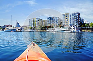 Modern apartment building exterior with glass museum and marina.