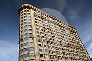 Modern apartment building exteriors against a blue sky with clou