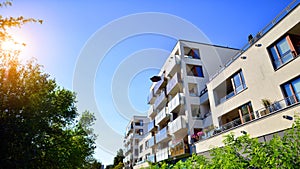 Modern apartment building and green trees. Ecological housing architecture.