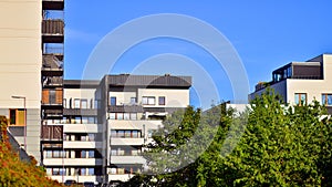 Modern apartment building and green trees. Ecological housing architecture.