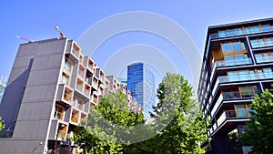 Modern apartment building and green trees. Ecological housing architecture.