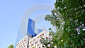 Modern apartment building and green trees. Ecological housing architecture.