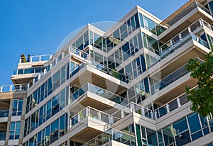 Modern apartment buildings exteriors in sunny day. Cityscape with facade of a modern housing construction with balconies