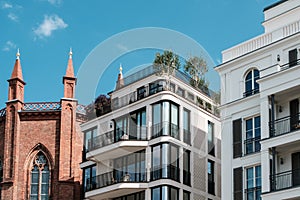 Modern apartment buildings and old church facade -  real estate Berlin, Mitte