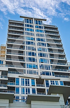 Modern apartment buildings on a sunny day with a blue sky. Facade of a modern apartment building with balconies. New apartment