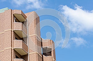 Modern apartment, hotel building on blue sky background from worm eyes view