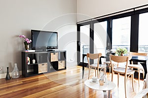 Modern apartment living room with bi fold door to balcony