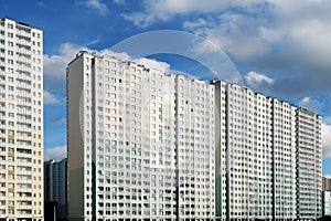 Modern apartment in a new high-rise residential building on a light blue sky background.