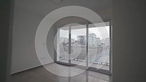 Modern apartment tour, bright unfurnished interior, spacious living room, large windows, cityscape views, potential for