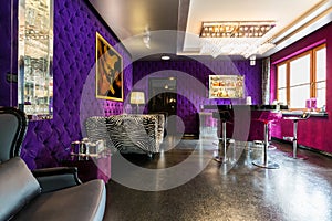 Modern apartment with upholstered violet walls