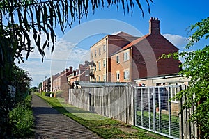 modern apartments along a riverside path on a sunny summers day