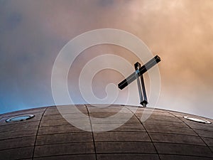 Modern architectural church detail with sunset background.