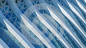 Modern architecture. Abstract pattern of shadows and light on curved diagonal lines of contemporary facade.