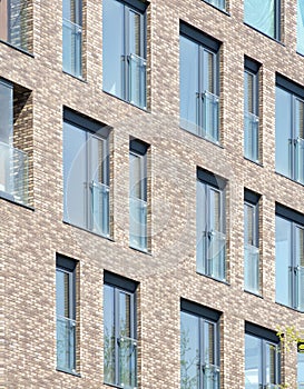 Modern architecture background. Rerctangular windows and clinker bricks fascade. photo