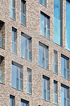 Modern architecture background. Rerctangular windows and clinker bricks fascade. photo