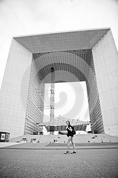 Modern architecture. Backpacker exploring city. Summer vacation. Woman stand in front of urban architecture. Must visit