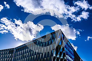 Modern architecture building with mirrors. Sky with clouds on th