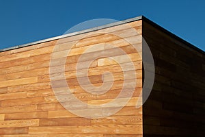 Modern Architecture detail of red cedar cladding wood facade, geometric shape, minimalist esthetics photo