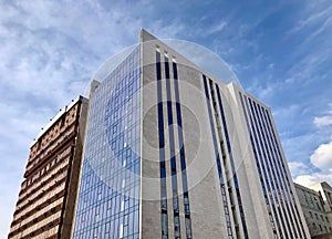 Modern architecture, glass facade with windows of residential or commercial, office building on a sunny day