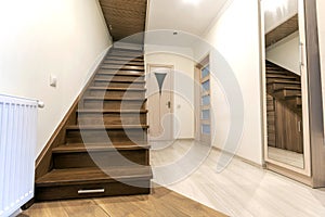 Modern architecture interior with elegant luxury hallway with glossy wooden staps stairs in modern storey house