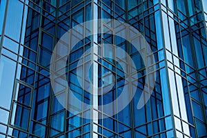 Modern Architecture Office Building Facade featuring Bluetinted Glass Panels and complex Geometric Pattern. Reflective photo