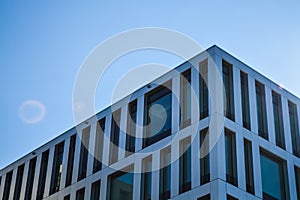 Modern architecture of office buildings. A skyscraper from glass and metal. Reflections in windows of blue sky. Business center