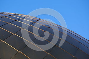 Modern architecture - the roof of the building in the form of a dome of metal rectangular plates