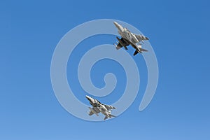 Modern armed military fighter jets flys in formation through the sky