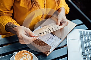 Modern astrologer numerologist woman working and writing in notepad numbers. Numerology, astrology photo