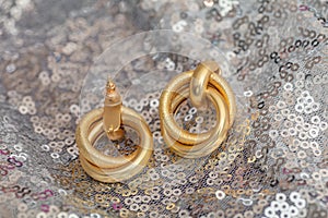 Modern asymmetrical golden earrings with layered rings